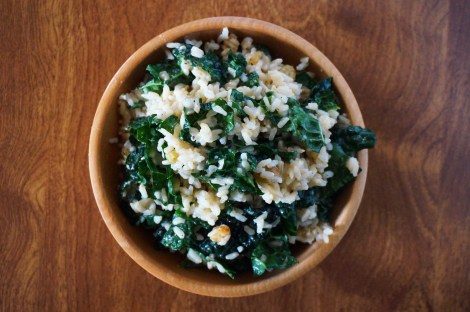 Sweet-salty brown rice salad, heaped in a wooden bowl, as seen from above