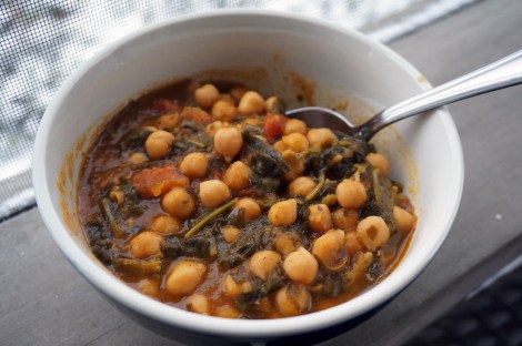 Chickpea stew with Ethiopian flavors, sitting on a porch rail. The snow-covered ground is visible behind it.